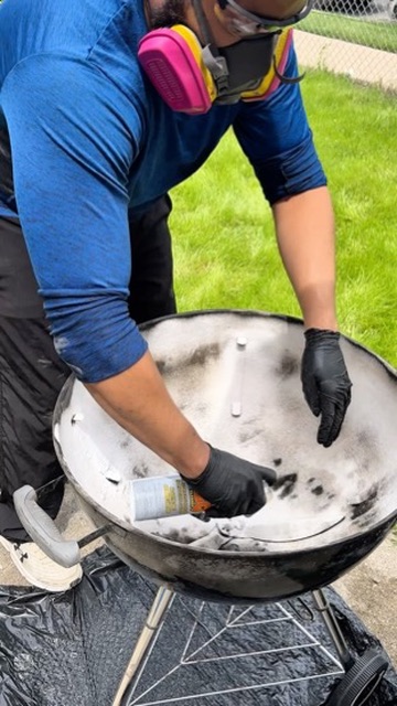 Campbell Grill Detail technician deep-cleaning a kettle grill
